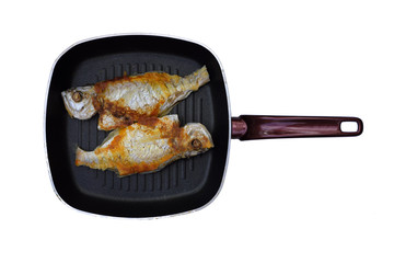 Fried fish in pan, bass cooking, copy space