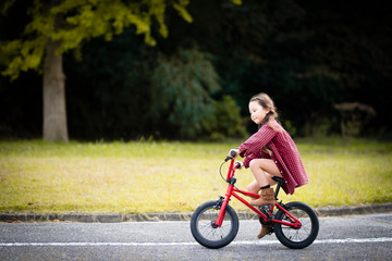 赤い自転車に乗る女の子