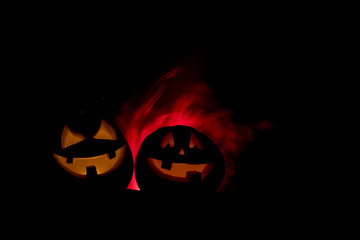 Group of Halloween Jack o Lanterns at night with a rustic dark foggy toned background