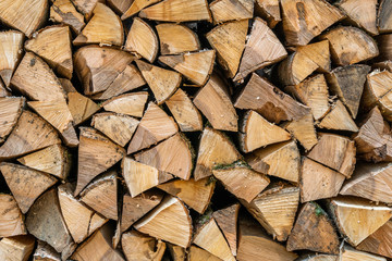 a stack of chopped firewood lies in the yard