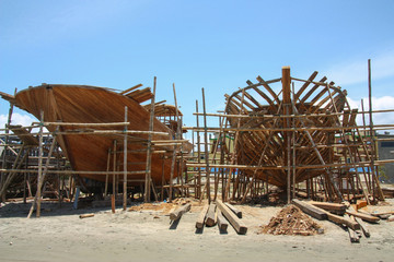 Fototapeta na wymiar Wooden ships under construction on a beach in Ecuador.
