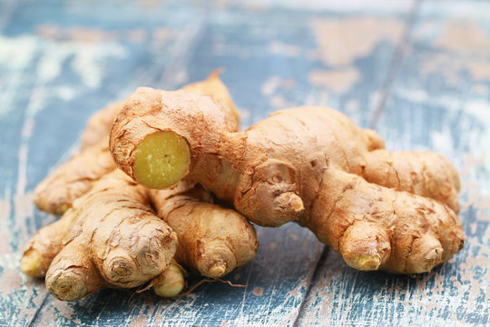 Closeup Of Fresh Root Of Ginger On Blue Rustic Wooden Surface Stock Photo Adobe Stock