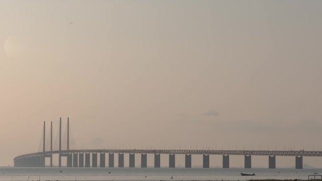 A Big Bridge, Cars Pass Over The Bridge, Both May Be Evening Sun And Morning Sun.