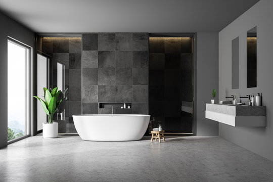 Black tile bathrom interior, tub and sink