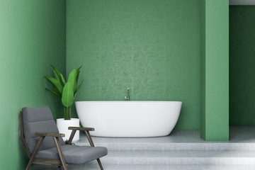 Green bathroom interior, white tub and armchair