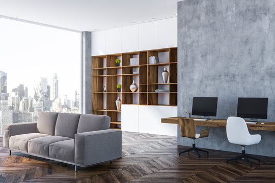 Gray home office corner, bookcase and sofa