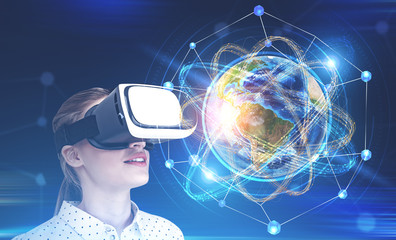 Woman in vr glasses looking at earth as atom