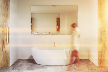 White and wooden bathroom, tub and mirror, woman