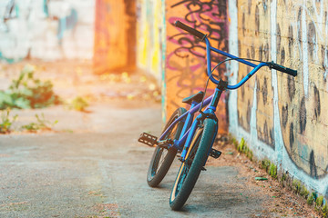 bike fix on the background wall with graffiti. sunshine background