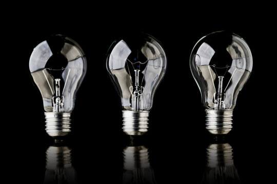 creativity startup business ideas concept with glow light bulb on black background