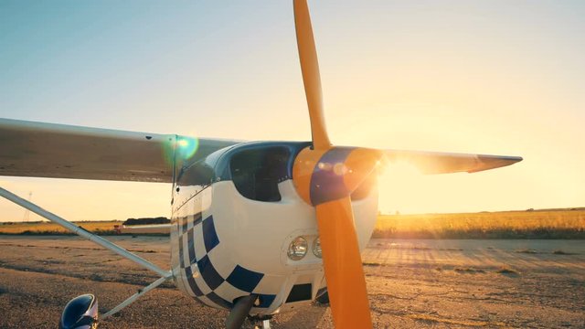 Close up of cropeduster's nose with a propeller on it in rays on sun