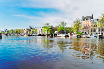 Naklejka premium embankment of Amstel canal in Amsterdam, Netherlands