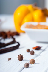 allspice and vanilla beans, quince jelly dessert ingredients on white wood table