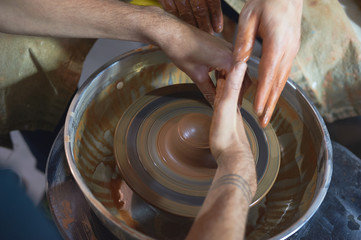 Master class on modeling of clay on a potter's wheel In the pottery workshop
