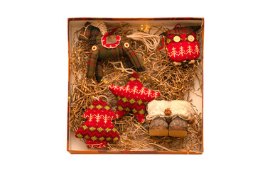 Vintage rag knitted Christmas toys in a box with thatched bedding and lights. Retro style. Isolate on white background.