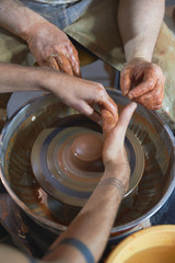 Master class on modeling of clay on a potter's wheel In the pottery workshop