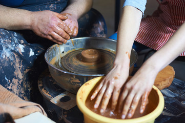 Master class on modeling of clay on a potter's wheel In the pottery workshop