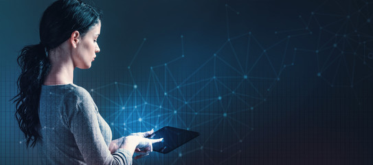 Technology links with grid with business woman using a tablet computer