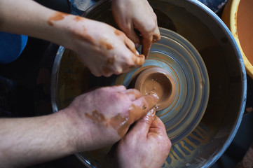 Master class on modeling of clay on a potter's wheel In the pottery workshop