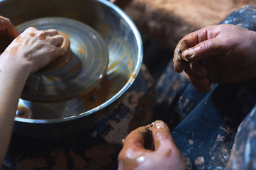 Master class on modeling of clay on a potter's wheel In the pottery workshop