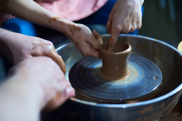Master class on modeling of clay on a potter's wheel In the pottery workshop