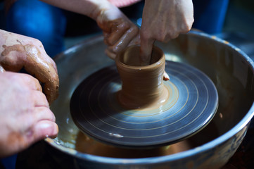 Master class on modeling of clay on a potter's wheel In the pottery workshop