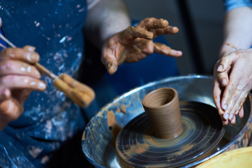 Master class on modeling of clay on a potter's wheel In the pottery workshop