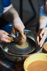 Master class on modeling of clay on a potter's wheel In the pottery workshop