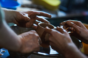 Master class on modeling of clay on a potter's wheel In the pottery workshop