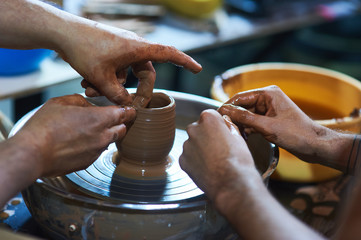 Master class on modeling of clay on a potter's wheel In the pottery workshop