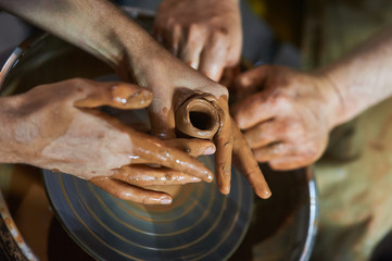 Master class on modeling of clay on a potter's wheel In the pottery workshop
