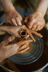 Master class on modeling of clay on a potter's wheel In the pottery workshop