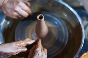 Master class on modeling of clay on a potter's wheel In the pottery workshop