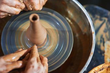 Master class on modeling of clay on a potter's wheel In the pottery workshop