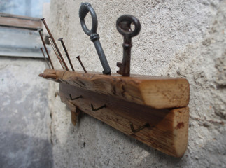 Wooden rustic style handmade key holder with rusty nails and keys