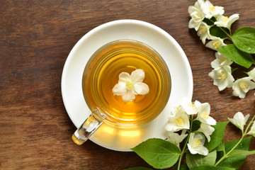 Green tea with jasmine blossom, top view 
