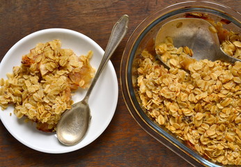 Oatmeal apple crumble in a baking dish, top view 