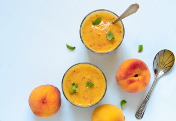 Peach slush with mint in glasses, top view, copy space