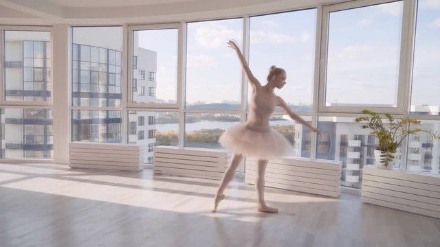 professional graceful ballerina dancing in the classroom on socks. woman is spinning 4k