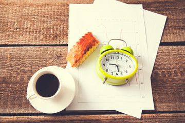 cup of coffee and clock on document paper