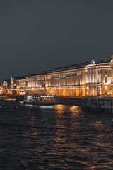 Naklejka premium The formal architecture of St. Petersburg. The bridges and the river Neva embankment. Sunset over the city.