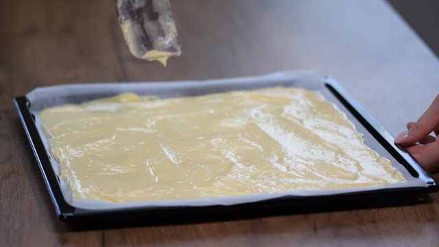 The sponge cake batter in the baking sheet