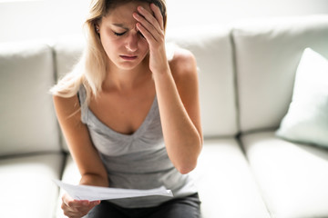 Obraz premium Blonde Beautiful woman stressed because of bills