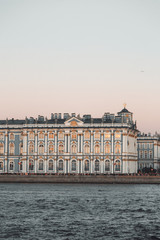 Fototapeta na wymiar The formal architecture of St. Petersburg. The bridges and the river Neva embankment. Sunset over the city.