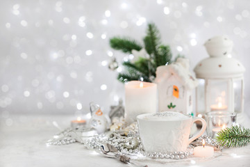 White cup of hot cappuccino coffee on holiday white and silver background, Christmas concept