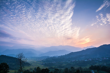 Village farm field and hill sunset