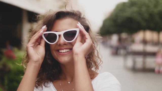 Stylish Woman Wearing Sunglasses Standing On City Street. Close up