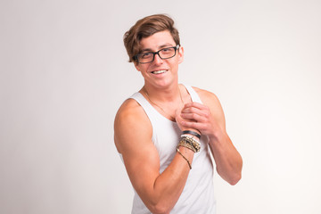 Portrait of funny handsome muscular nerd man on white background