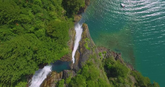 Aerial view of the Bride waterfall that empties into the lake Tagua Tagua, with native forest around it.