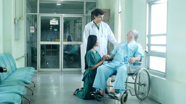 Nurse and doctor talking with senior man at hospital. People with healthcare and medical concept. 4k resolution.